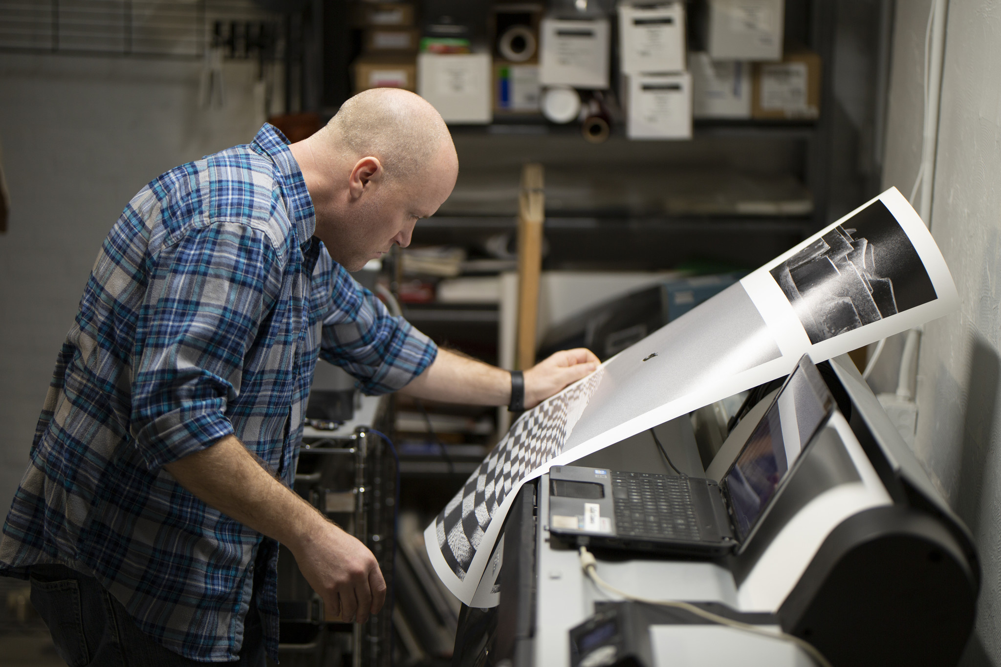 Jason Robinson, our print technician, reviews a print for color-correctness and quality. 