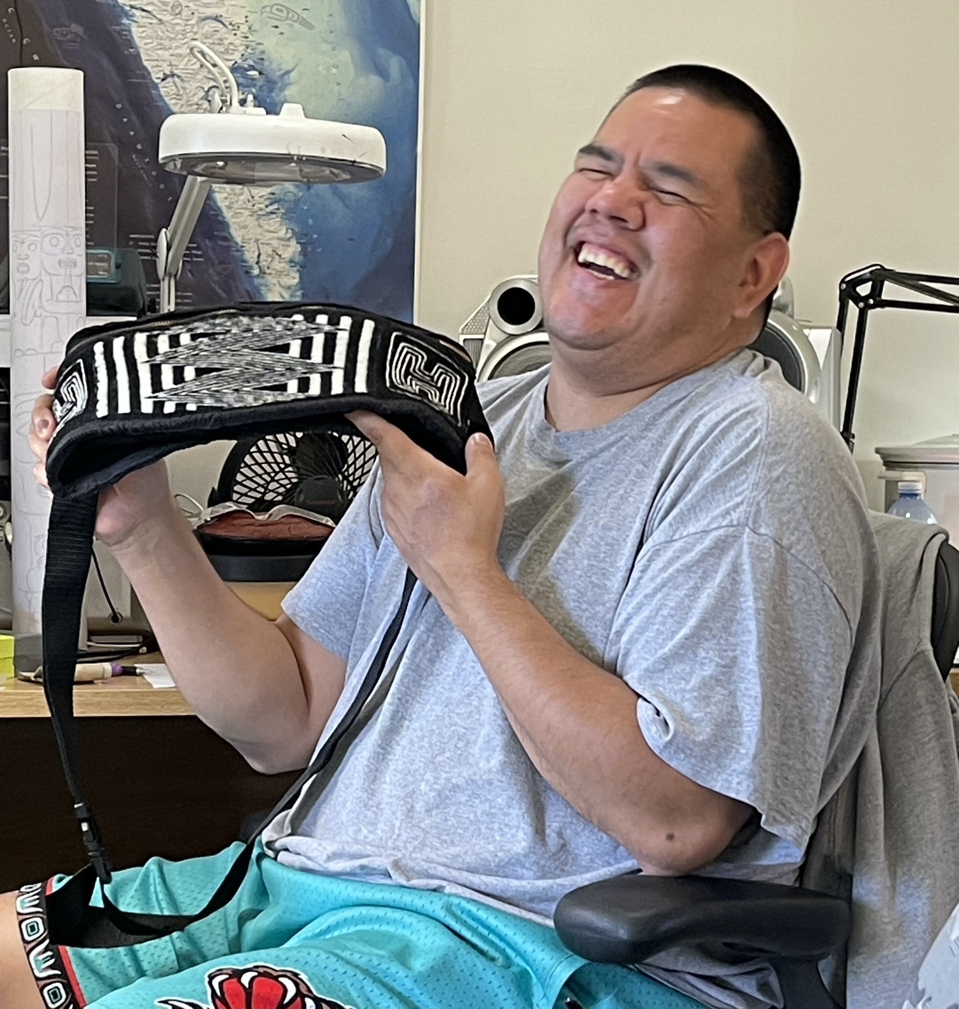 Jay Simeon at his workshop receiving Ravenstail weaving by Cheyenne Gwaamuuk