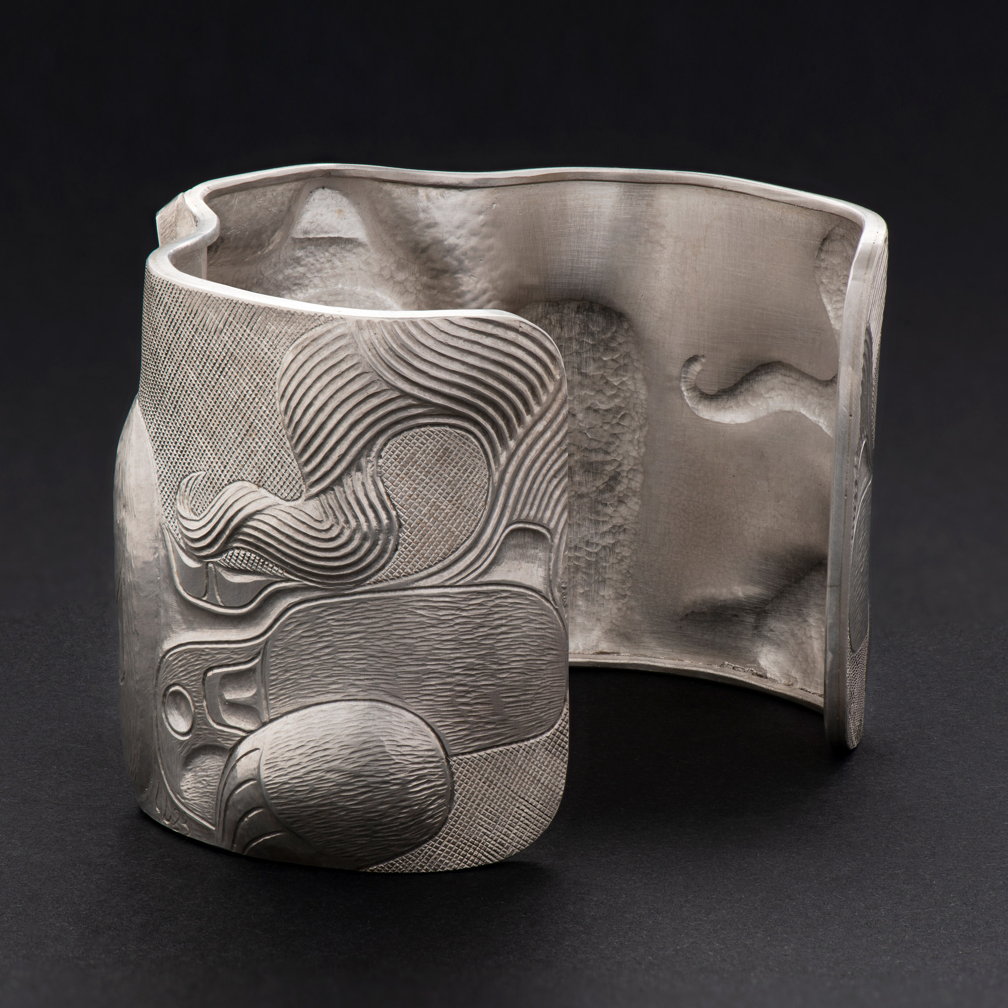 Haida Silver Repousse Wolf Bracelet by Jay Simeon