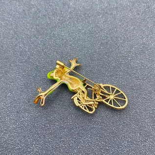 WHIMSICAL FROG ON A BIKE PIN