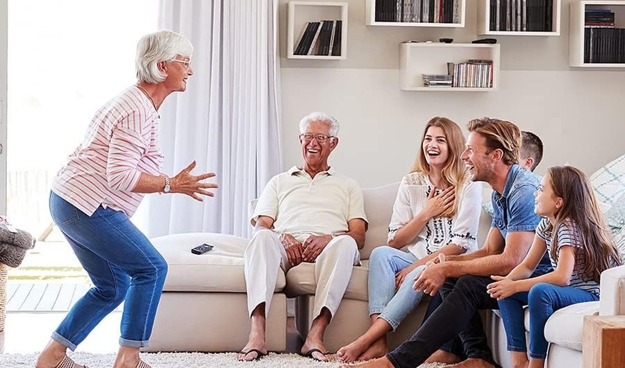 A family playing a game of charades in their living room.