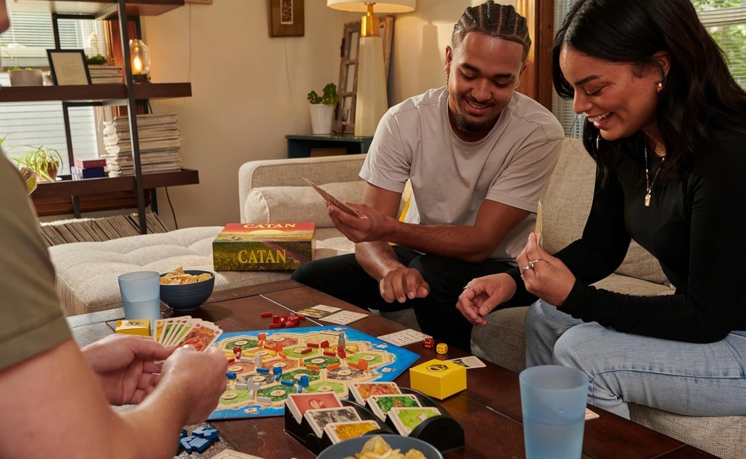 A group of friends playing the Catan board game.