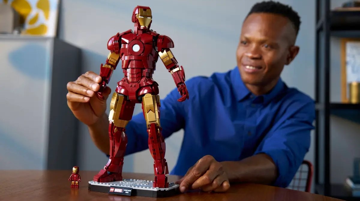 A person building the Iron Man Mark 3 Collectors Lego Set.