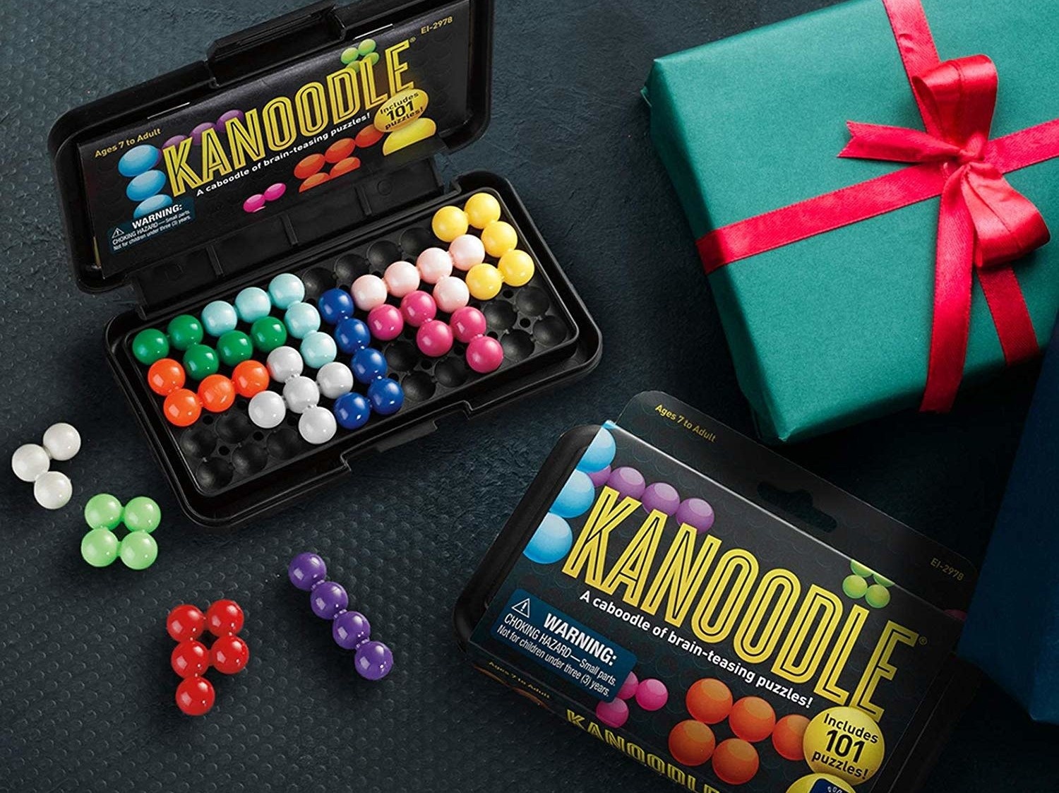 A photo of the Kanoodle game alongside gift packaging.