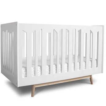 white crib with wood legs