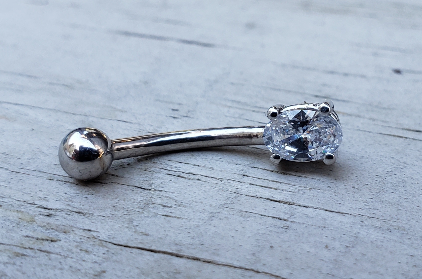 14g 7/16 Oval Prong Navel Curve by Body Gems