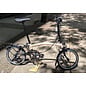 Brompton 2026 Brompton C Line 12spd - Mid - Rack - Dune Sand / Black