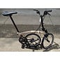 Brompton 2026 Brompton C Line 12spd - Mid - Rack - Dune Sand / Black