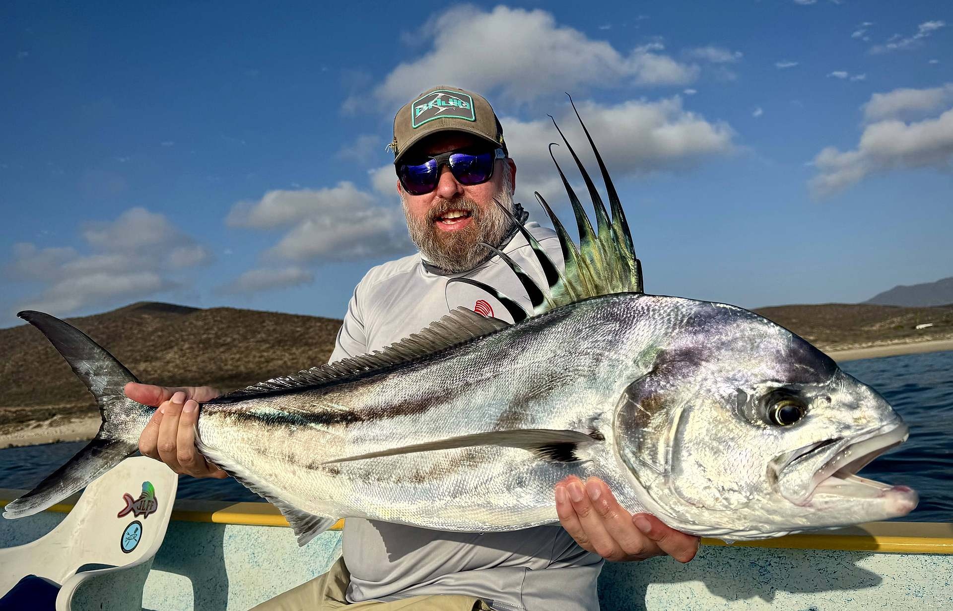 Baja House, MX Fishing - angler standing on boat with fly rod