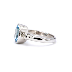 American Jewelry 14k White Gold Bezel Oval Blue Topaz & 1/7ctw Diamond Ladies Ring (Size 6)
