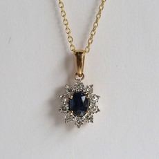 American Jewelry 14k Yellow Gold .16ctw Round Brilliant Diamond .74ctw Oval Sapphire Halo Necklace