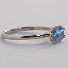 American Jewelry 10kw .12ctw Diamond Baguette Blue Topaz Halo Ring (Size 7)