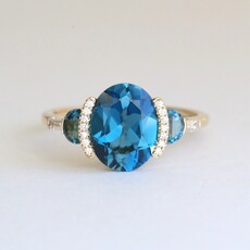 American Jewelry 14k Yellow Gold 3.37ctw London Blue Topaz .11ctw Diamond Three Stone Ring