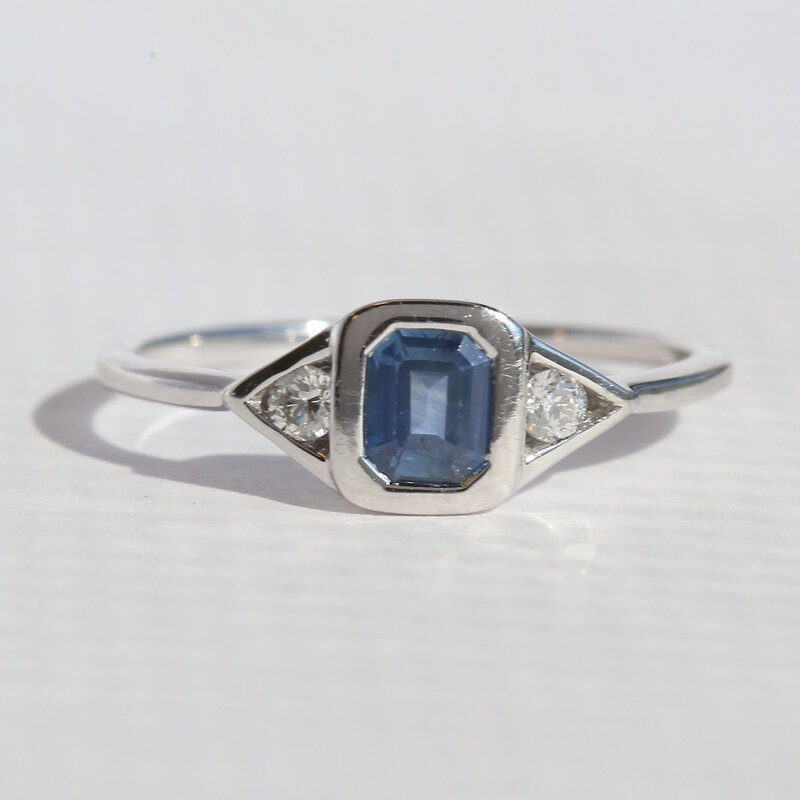 American Jewelry 14k White Gold .65ct Sapphire .10ctw Diamond Emerald Cut 3 Stone Ring