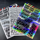 Team Zombie D-TZ-6800BWH Team Zombie Black, White & Holographic 6" x 8" Die-Cut Sticker Sheet (3pcs, 1ea Color)