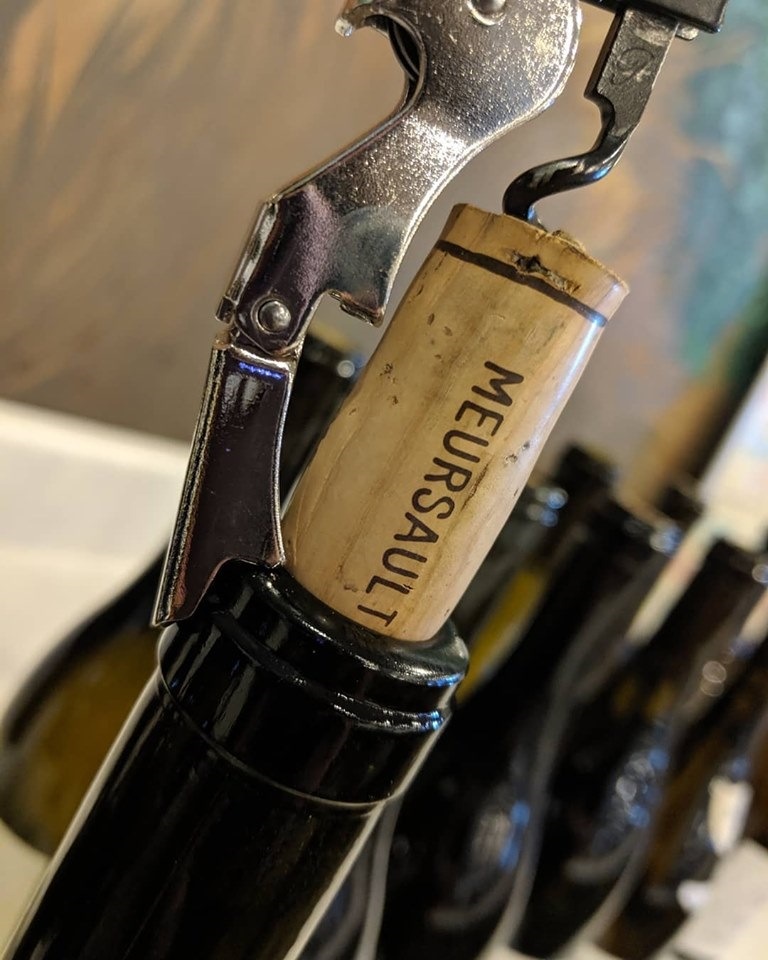 Opening a bottle in Meursault