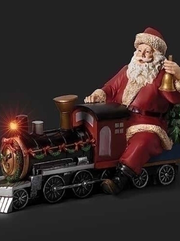 Père Noël assis sur locomotive musical à piles