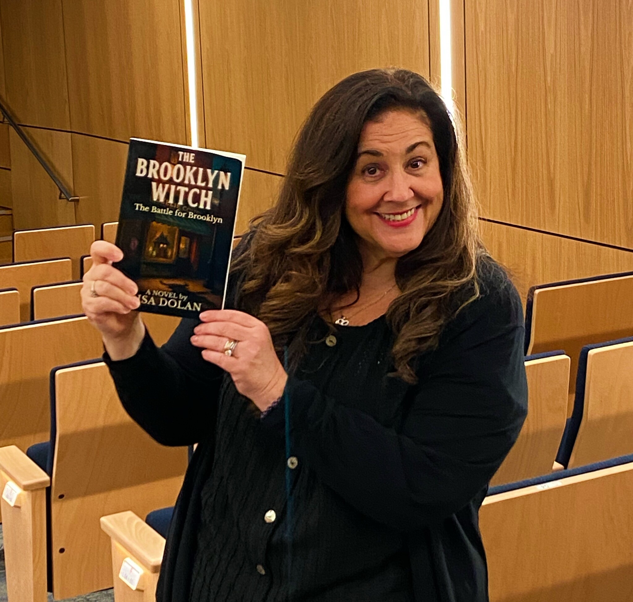 Lisa Dolan holding The Brooklyn Witch