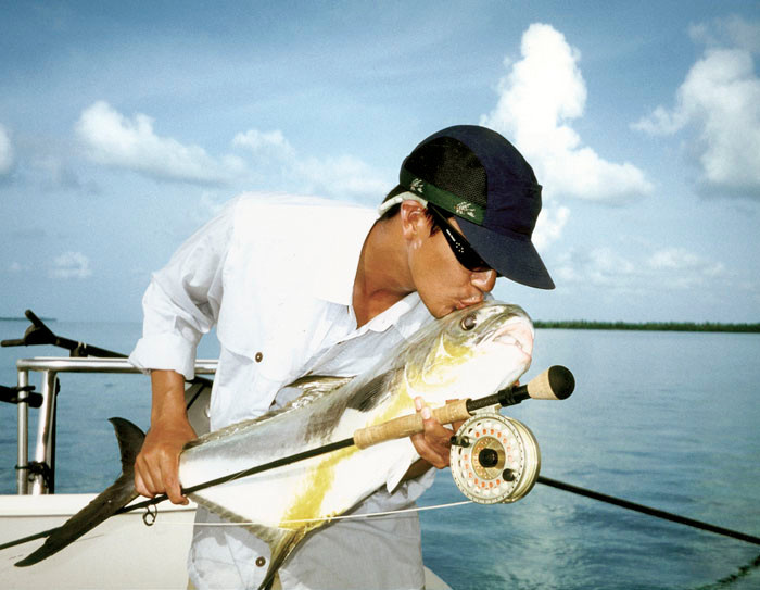 A nice permit on fly from 2007, a happy angler, and a fleeting moment. 
