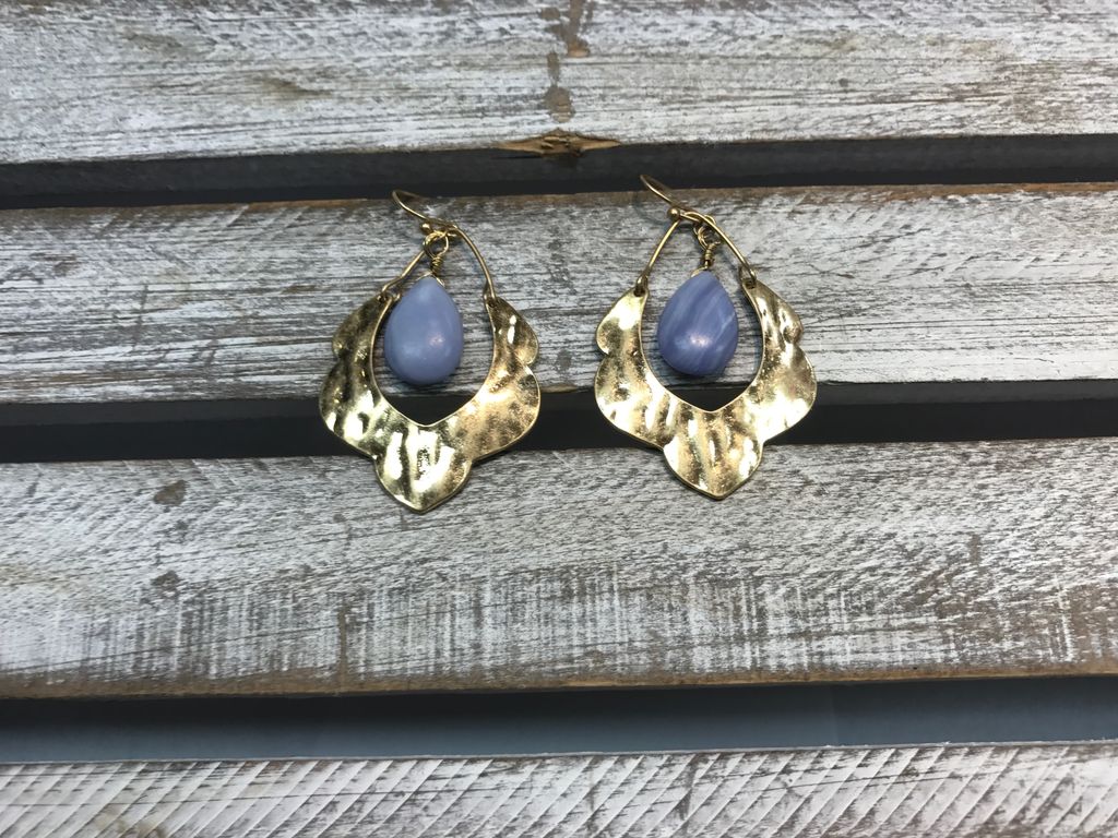 Gold Earring with a Light Blue Stone in the Middle