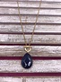 Long Gold Necklace with a Blue Stone Pendant