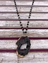 Long Gold Necklace with Black Beads and a Black Geode Pendant