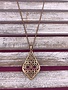 Long Gold Necklace with a Teardrop Shaped Intricate Pendant