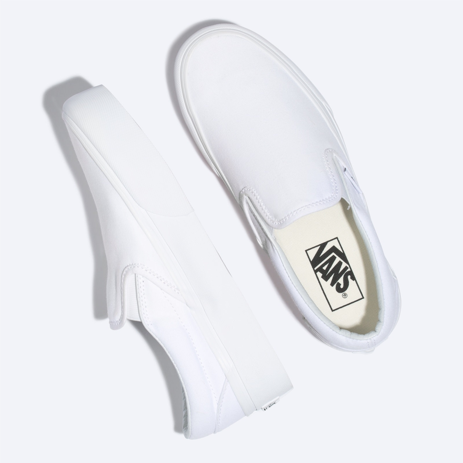 solid white slip on vans