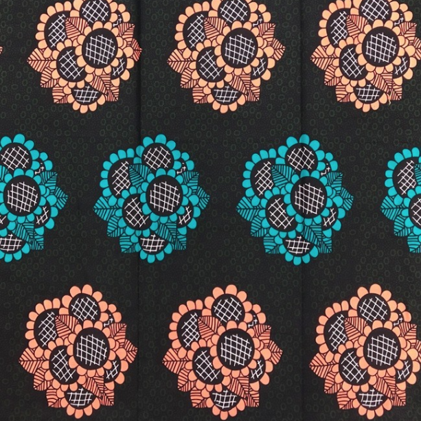 Fabrics USA Inc Ankara -  Peach and teal bouquets on olive and black background