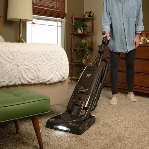 Riccar R27CV cordless upright vacuum cleaning under furniture