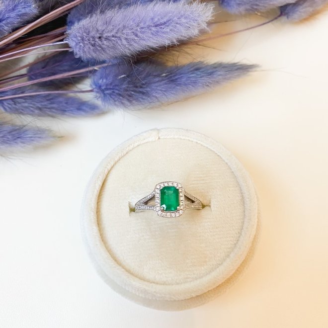 Emerald and diamond halo ring