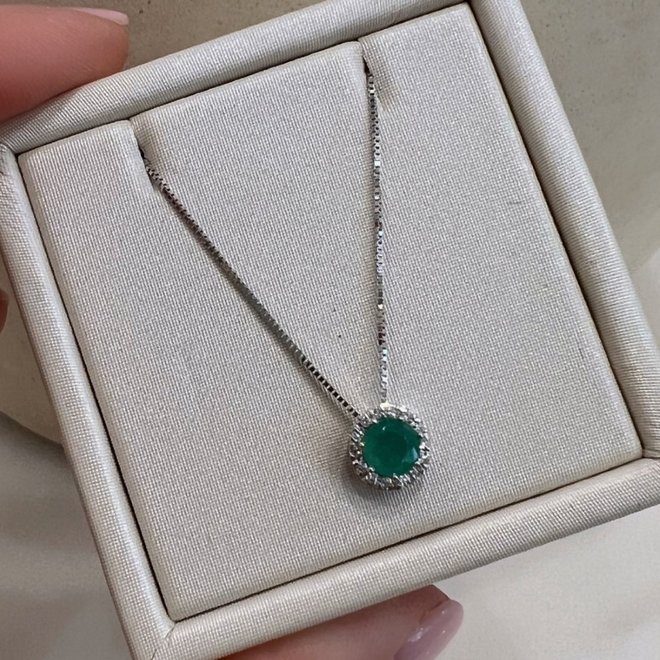 Emerald and diamond halo pendant