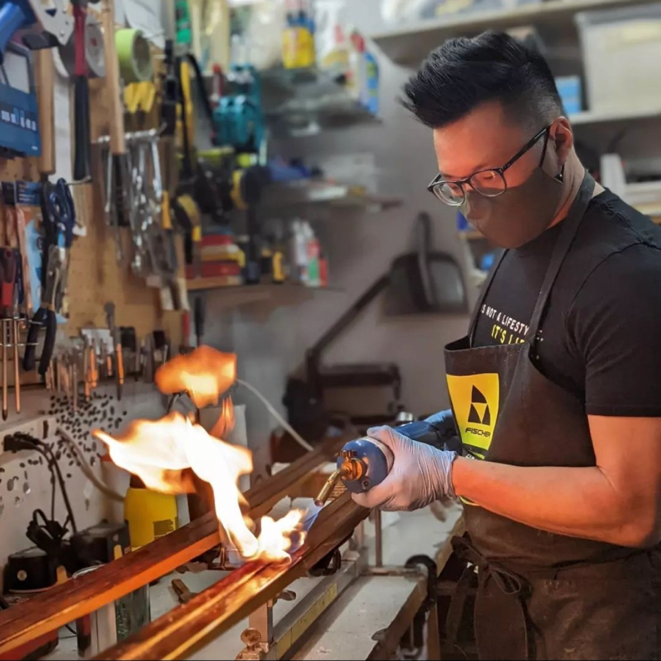 Applying glide wax to a cross-country ski base