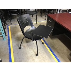 Black plastic right hand tablet arm chair on castors - some light scuffs throughout 6/12/25