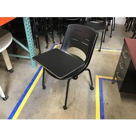 Black plastic left hand tablet arm chair on castors - some light scuffs throughout 6/12/25