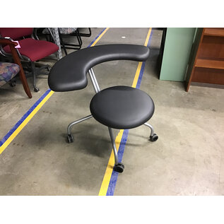 Grey rounded swivel chair on castors - designed for sitting backwards 6/13/25