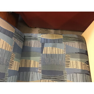 27 1/2” Wide blue and tan pattern cushioned seat sectional piece on castors - some wear and staining throughout 9/25/26
