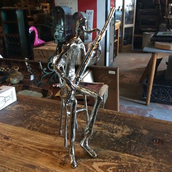 Aluminum figure playing oboe