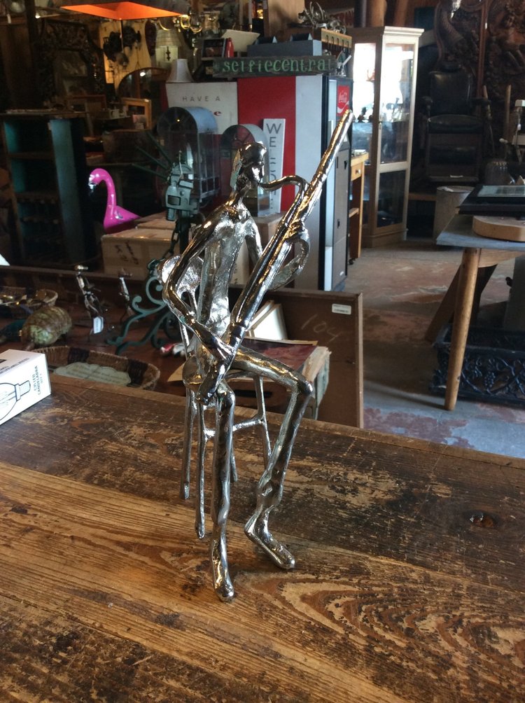 Aluminum figure playing oboe