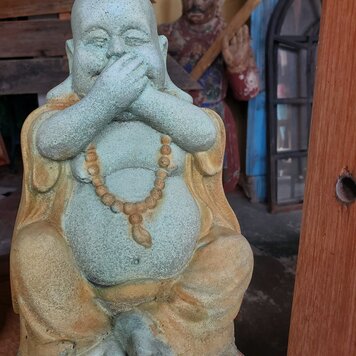 Monk hand over mouth