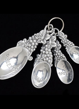 Arthur Court Designs Supply the ingredients for a beautiful cake with these elegant Grape Measuring Spoons from Arthur Court. <br />
<br />
Bundles of grapes, leaves and vines form the handles and give each spoon a unique grip. Handcrafted from lustrous aluminum, this four-piece set feat