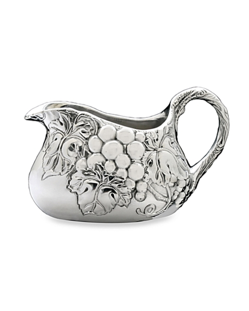 Arthur Court Designs Grape Gravy Boat<br />
Our grape motif displays on each side of this piece as darker lines define each veiny leaf and piece of fruit. Vines also twirl into view on the bottom of this handmade, aluminum boat before arching up to form the handle.