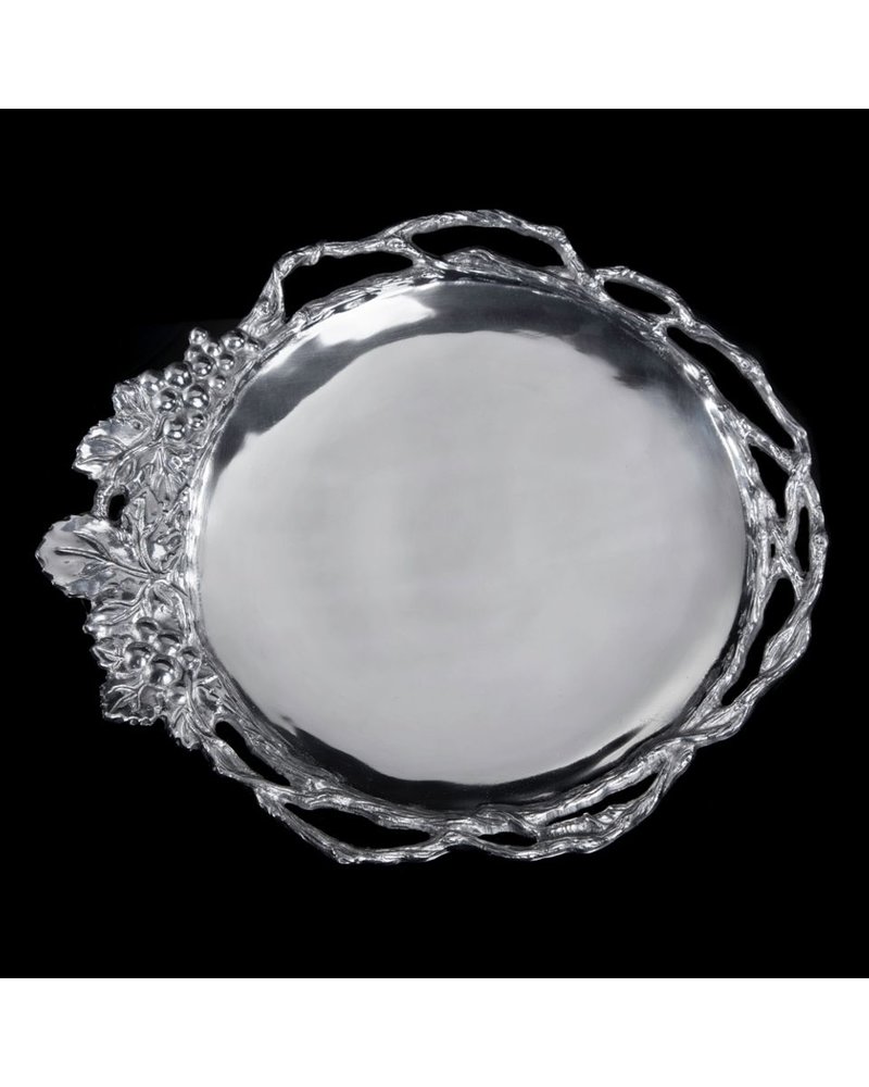 Arthur Court Designs Grape Vine Round Tray<br />
Twisting, openwork vines transition into a detailed collection of grapes and leaves on the edge of this handmade, aluminum dish. The lines defining the shape of the fruit and the marks in the vegetation form a textured border around