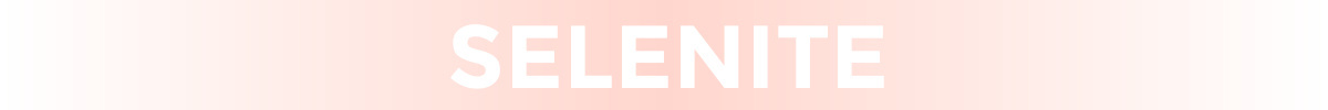 Gradient image fading between white and blush pink with text that reads "selenite" in white text