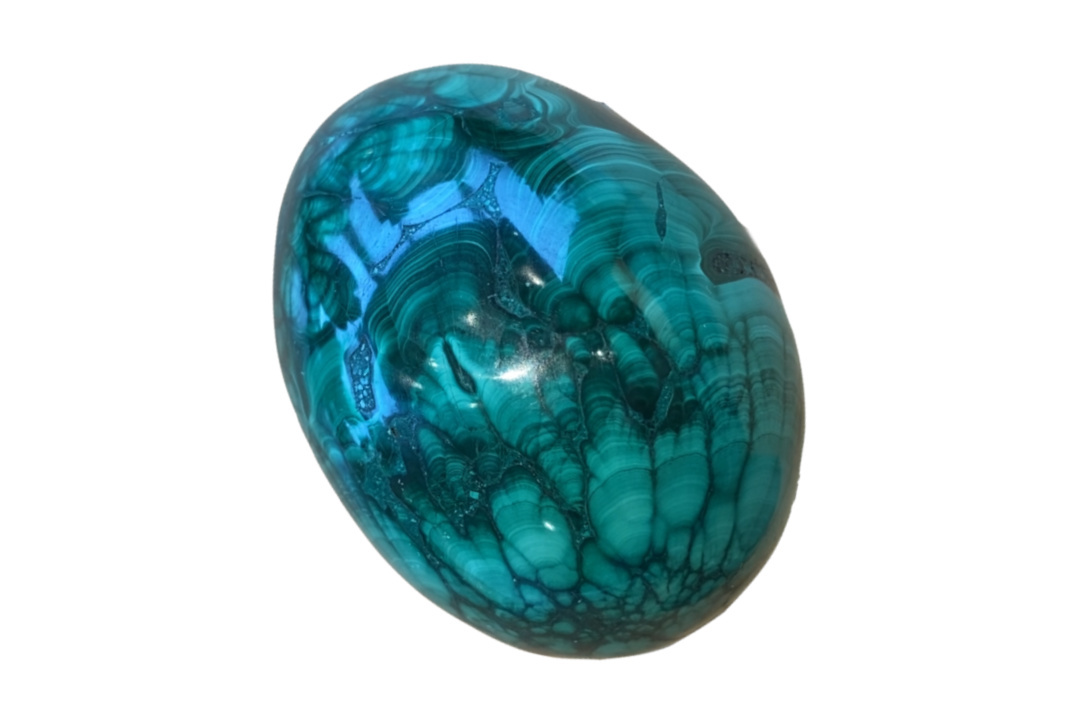 Circular shaped piece of malachite with intricate patterns of wave inclusions