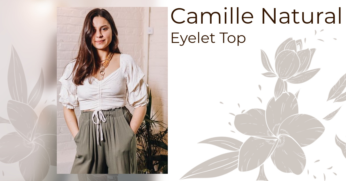 Photo of our Camille Natural Eyelet Lace Top; A creamy white eyelet crop top with cascading puffy half sleeves and a ruched front.