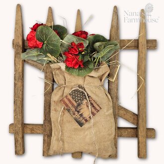 Picket Fence with Geranium In Burlap Bag