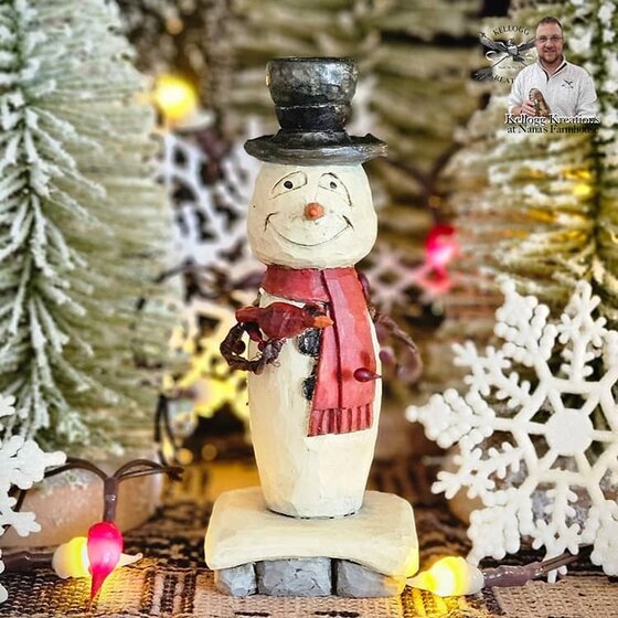 Snowman in Red Scarf holding Cardinal