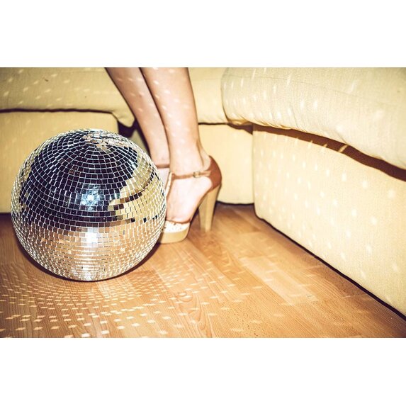 Getty Images Gallery Young woman wearing high heels standing by disco ball on floor in party by Westend61 via Getty Images Gallery