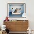 The Picturalist Fine Art Print on Rag Paper: Lion sitting on couch, side view by Matthias Clamer via Getty Images Gallery